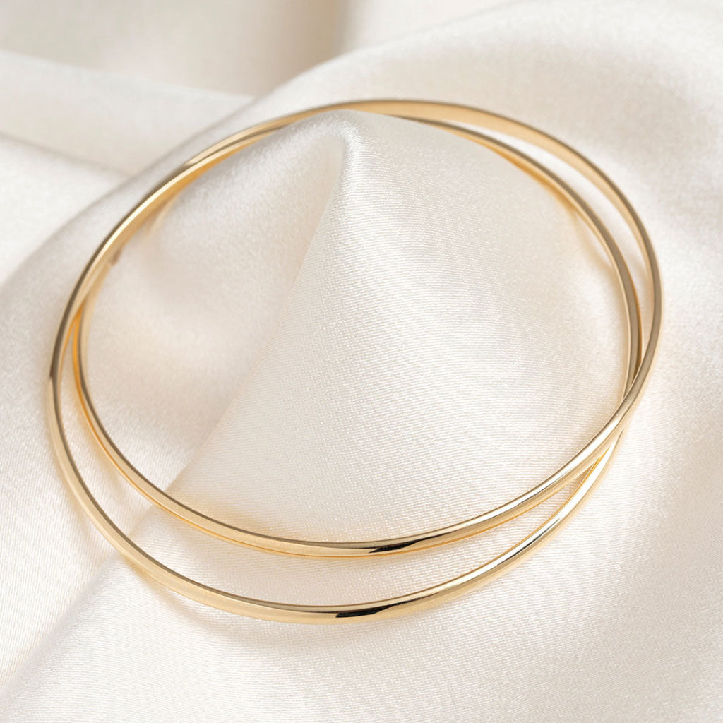 yellow gold bangle on fabric