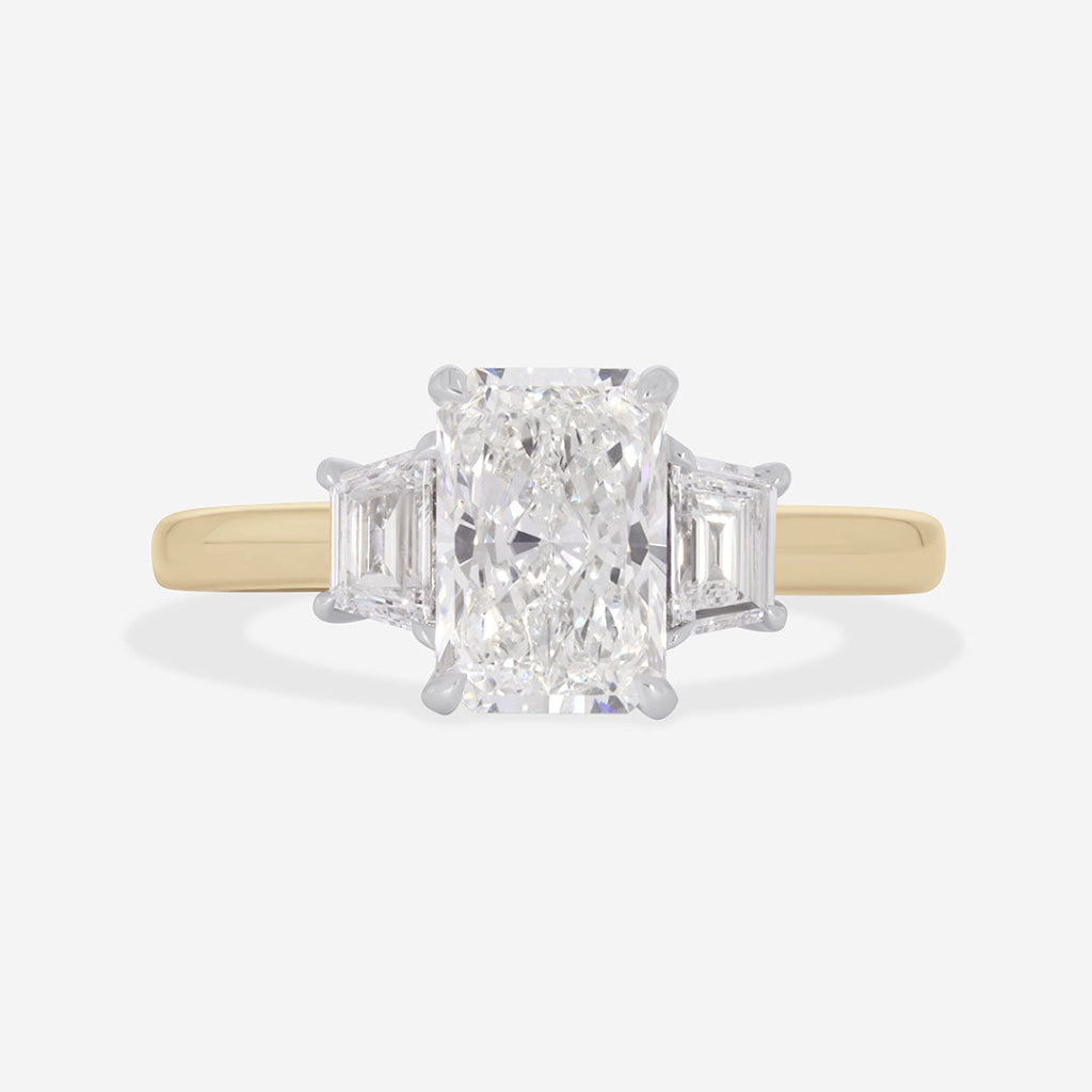 radiant cut three stone on yellow gold band