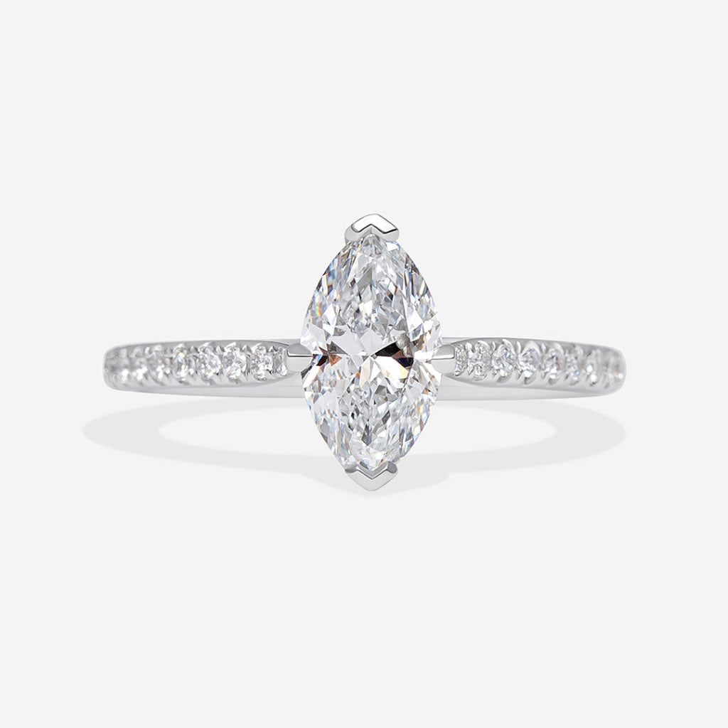 A platinum diamond ring featuring a marquise-cut center stone and pavé-set diamonds along the band.
