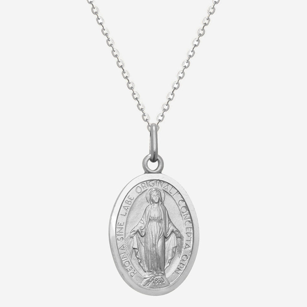 silver miraculous medal on white background