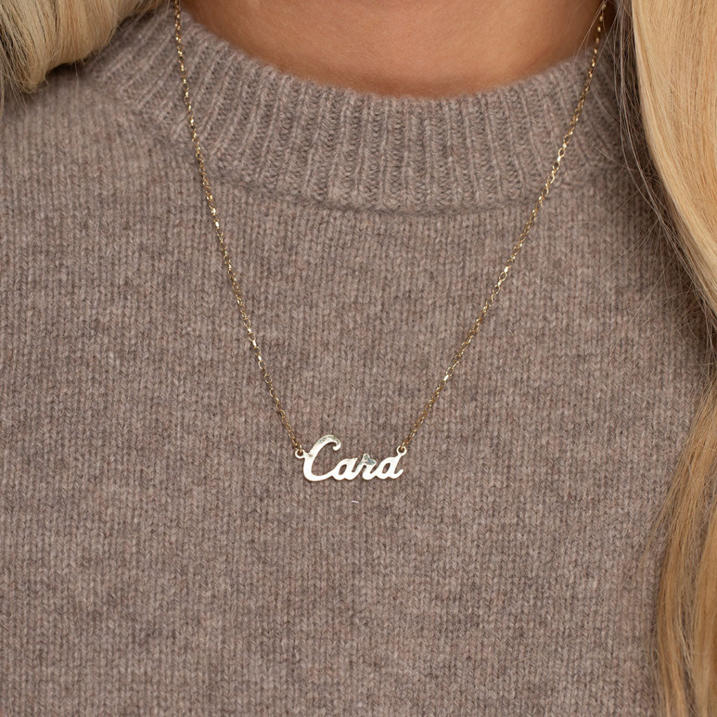 gold name chain on jumper