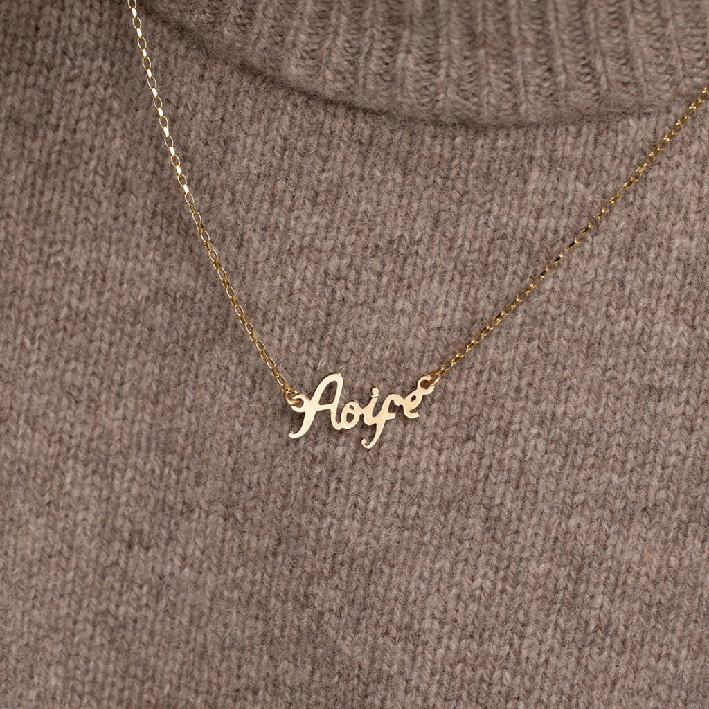 name chain on dark jumper