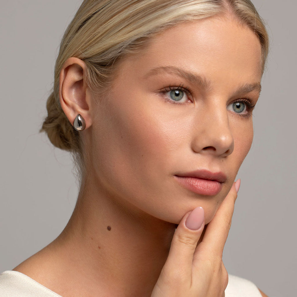 model wearing silver nugget earrings