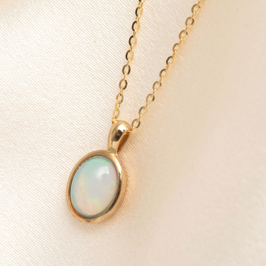 yellow gold bezel set opal pendant on chain