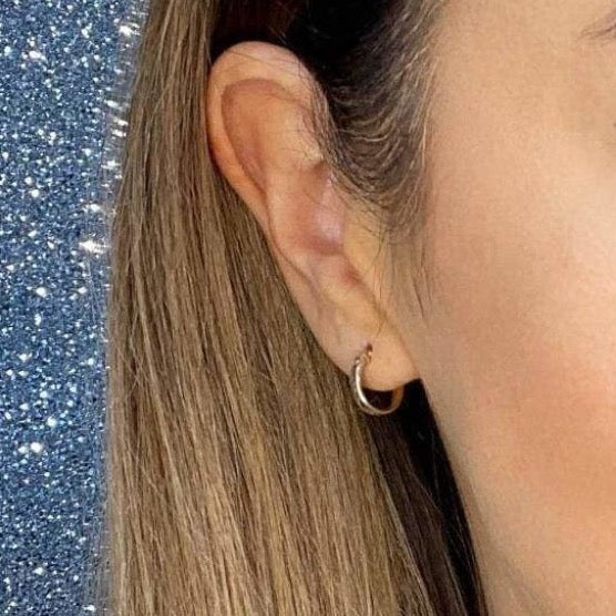 Woman wearing 9ct gold Diamond Cut Hoop Earrings | Gear Jewellers Dublin