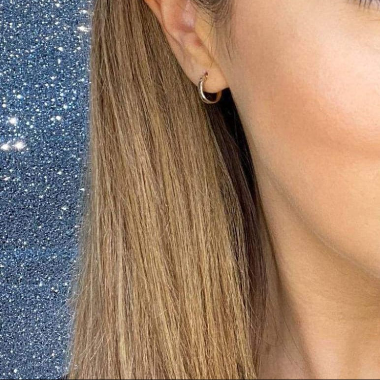 Woman wearing 9ct gold Diamond Cut Hoop Earrings | Gear Jewellers Dublin