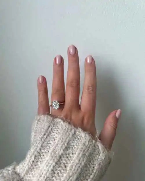 files/oval-diamond-engagement-ring-worn-hand-cream-knit-sweater.webp