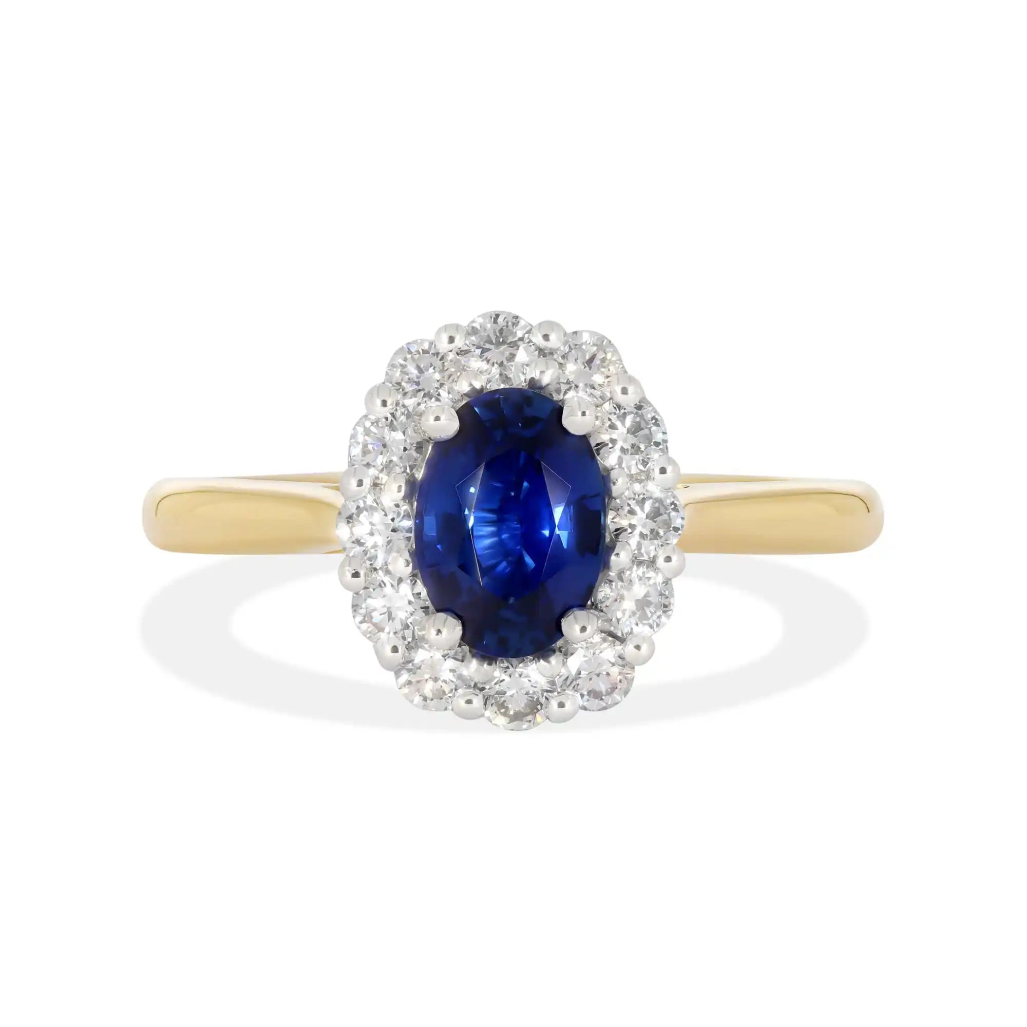 Oval sapphire ring with diamond halo on a gold band.