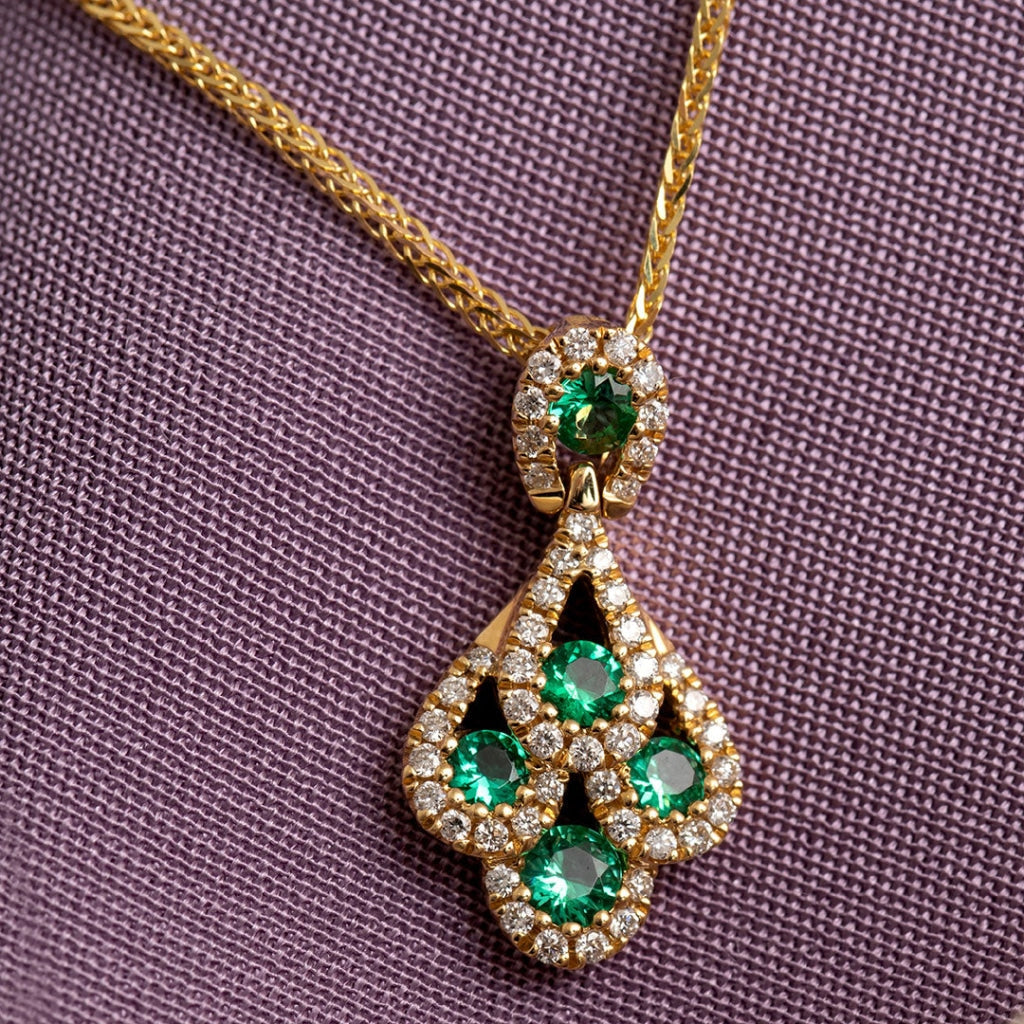 Peacock Emerald and Diamond Necklace on purple background