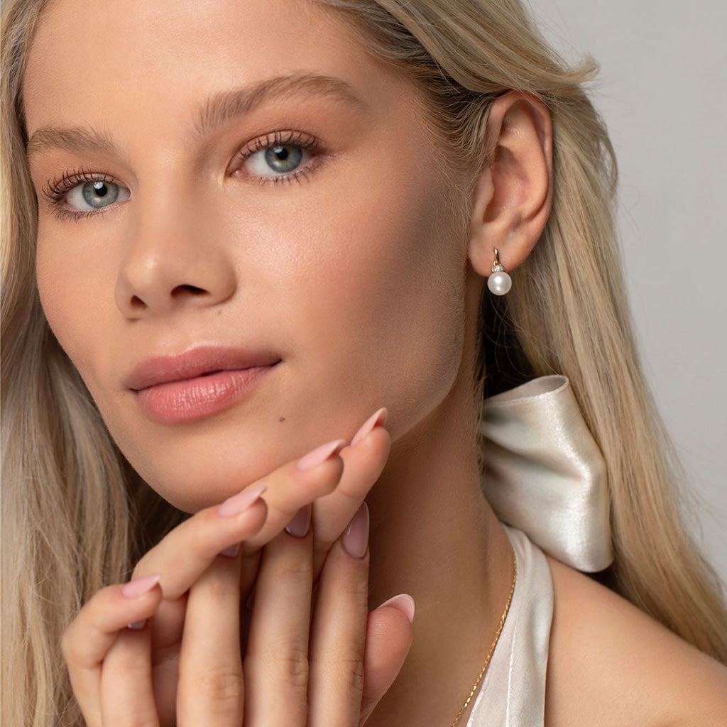 model wearing pearl earrings