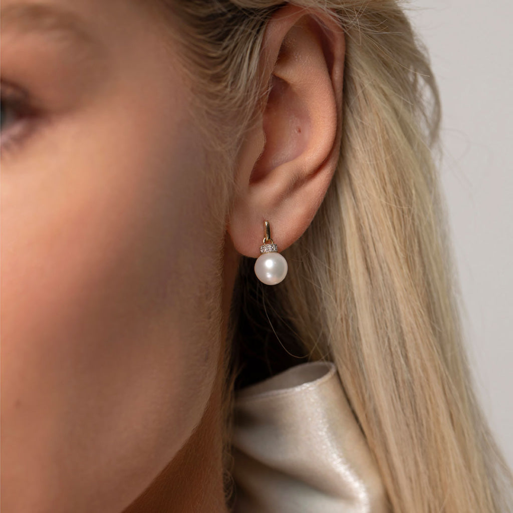 pearl drop earrings in ear