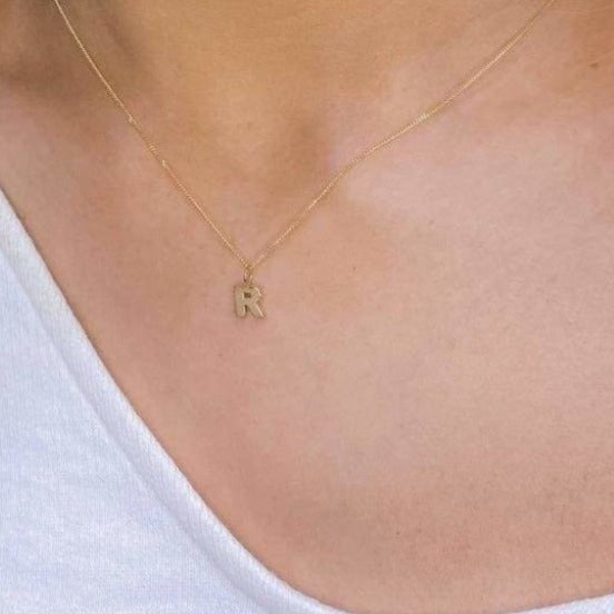 Woman wearing 9ct Gold R Initial Necklace