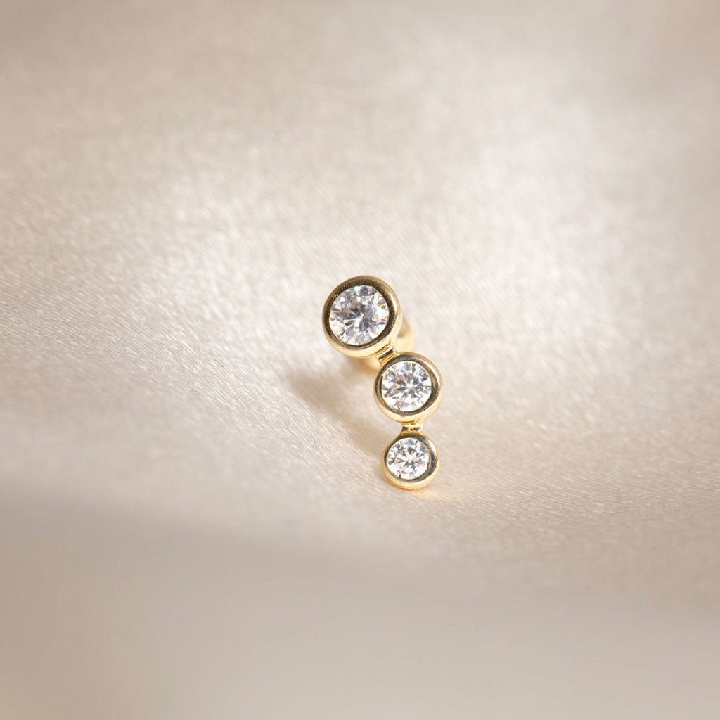 triple cubic zirconia piercing close up