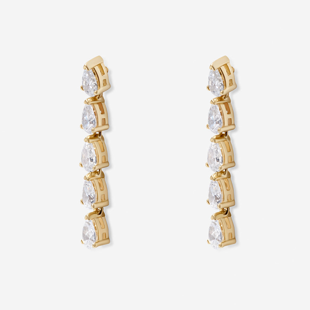 A pair of gold drop earrings featuring a vertical arrangement of five pear-cut diamonds in a claw setting.