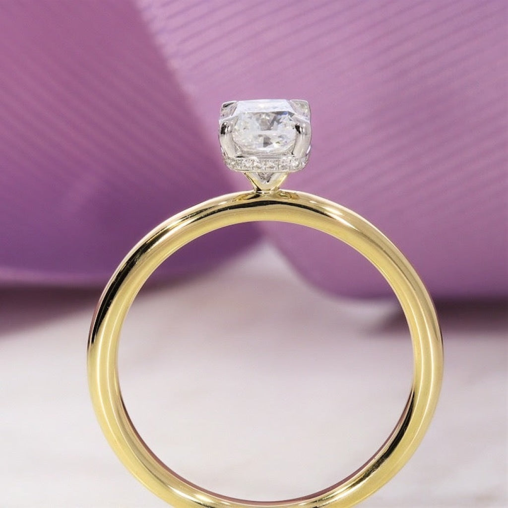 Photo of a diamond engagement ring on a purple background