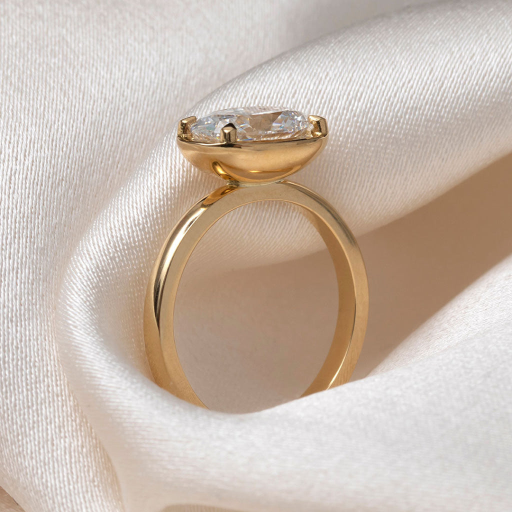 18ct gold oval diamond engagement ring in an east to west setting. 