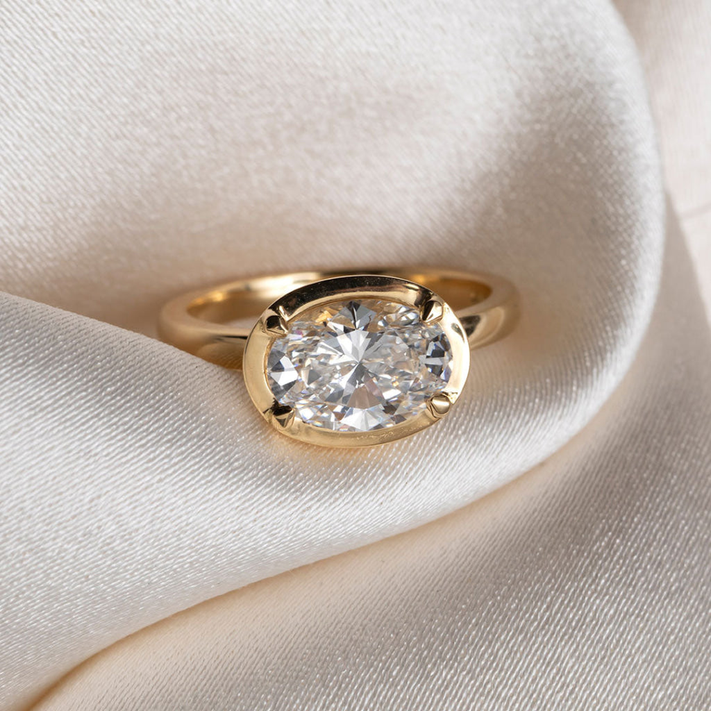 18ct gold oval diamond engagement ring in an east to west setting. 