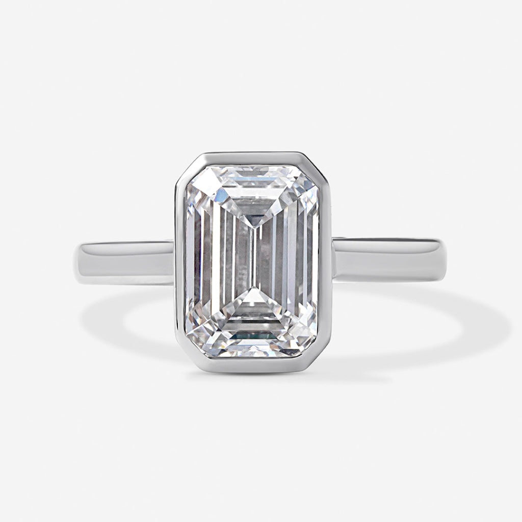 An emerald-cut diamond ring in a platinum band.