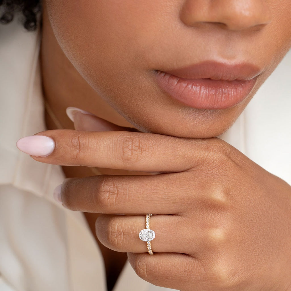 Rook oval halo diamond ring on models hand