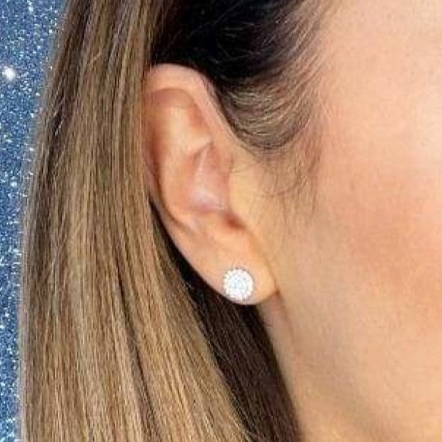 Woman wearing diamond earring.