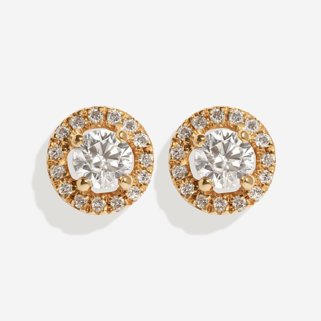 Halo diamond earrings on white background