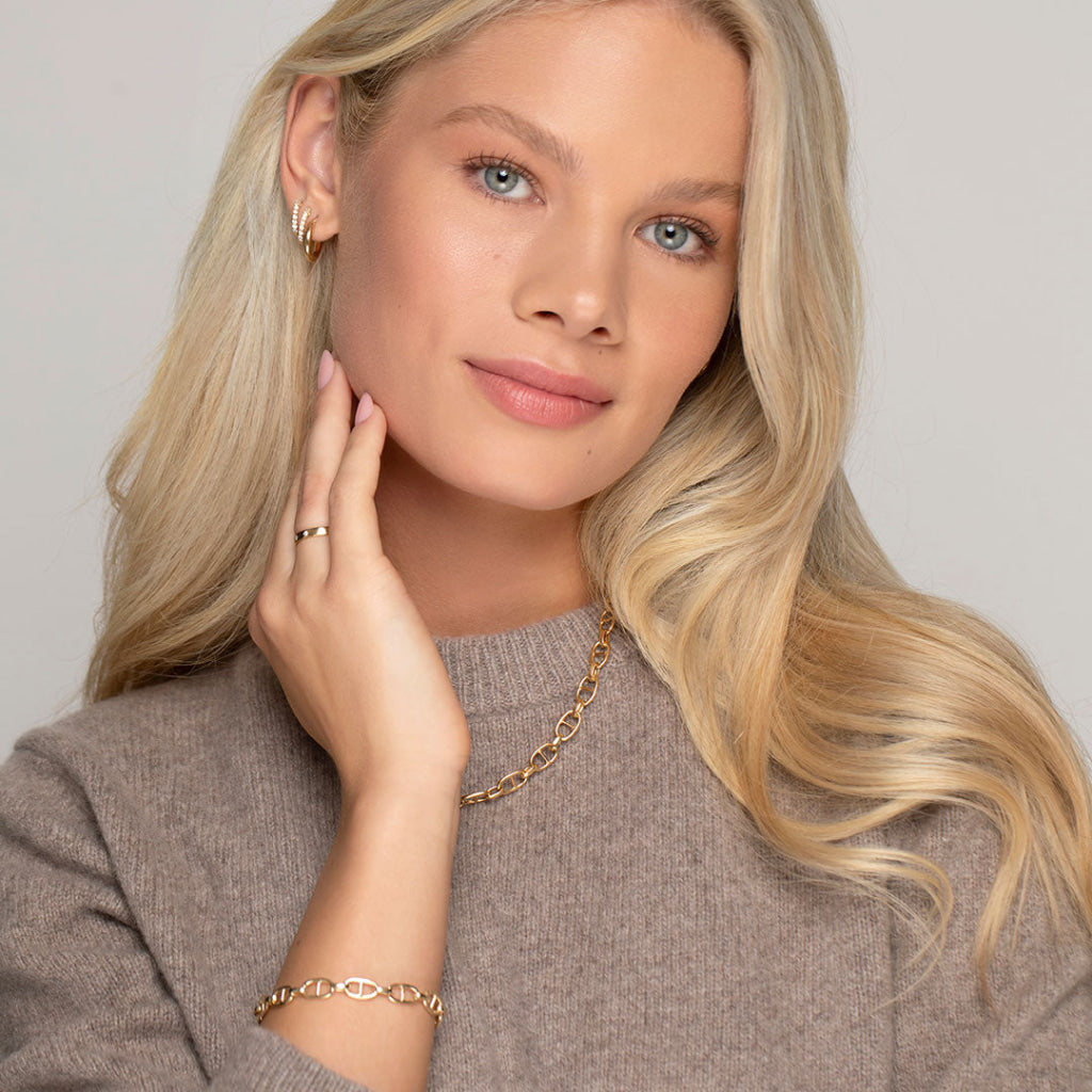 model wearing selection of gold jewellery