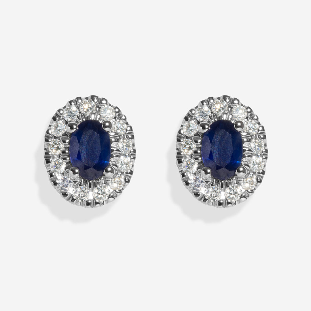 Oval sapphire and diamond earrings on white background
