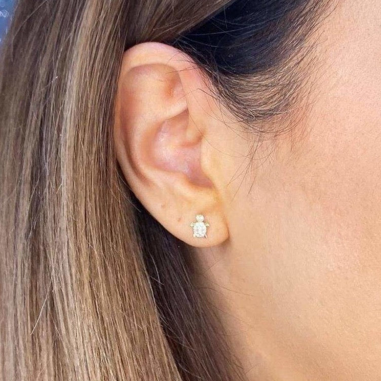 Woman wearing 9ct gold Sea Turtle Earrings | Gear Jewellers Dublin