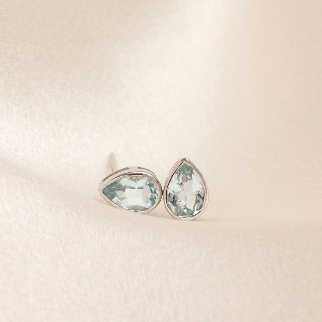 aquamarine pear cut bezel set earrings in white gold