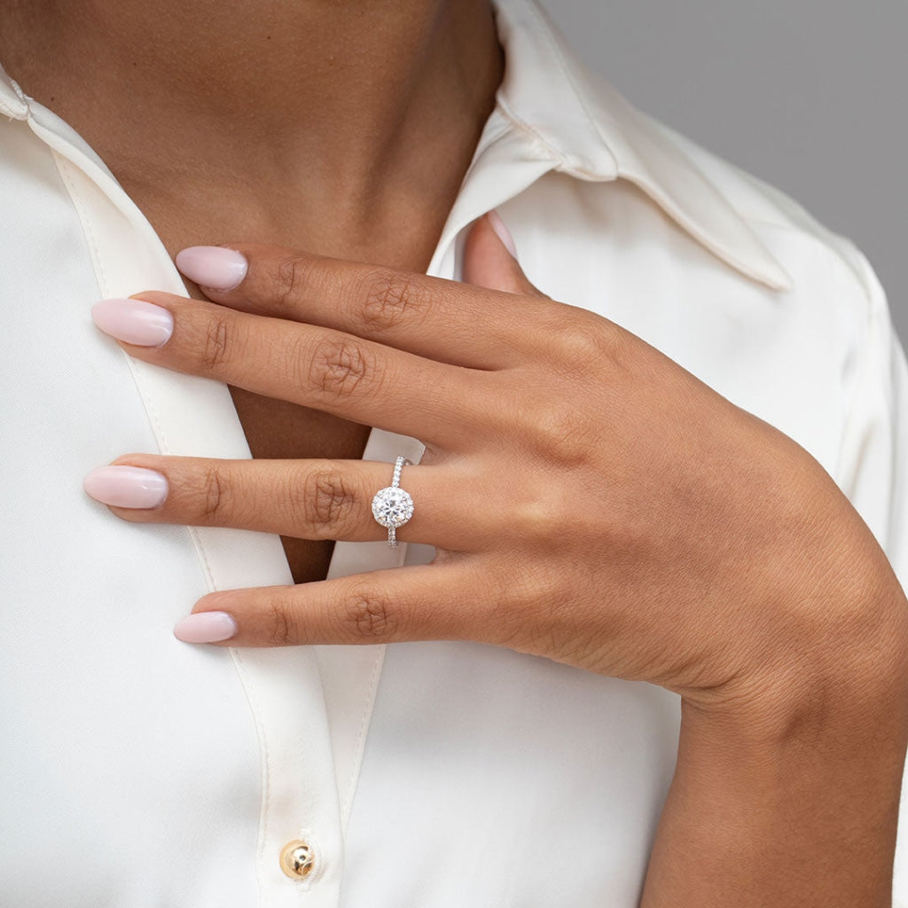 Round engagement ring on women's hand