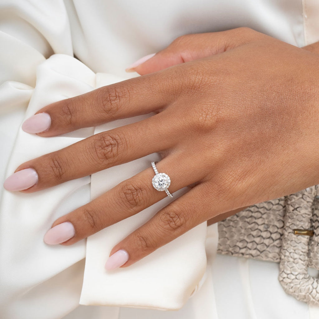 platinum round halo ring on women's hand