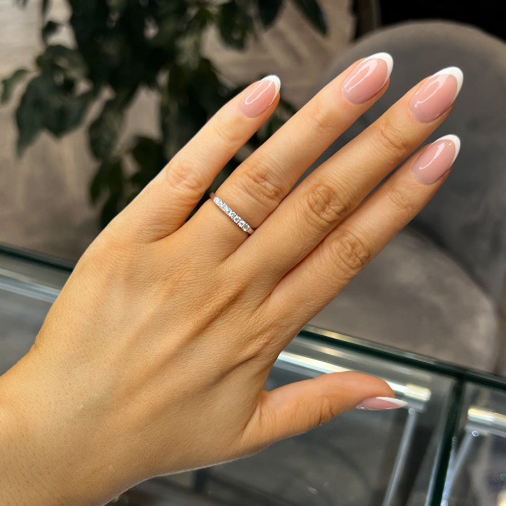 Woman's hand wearing the Mona diamond eternity ring