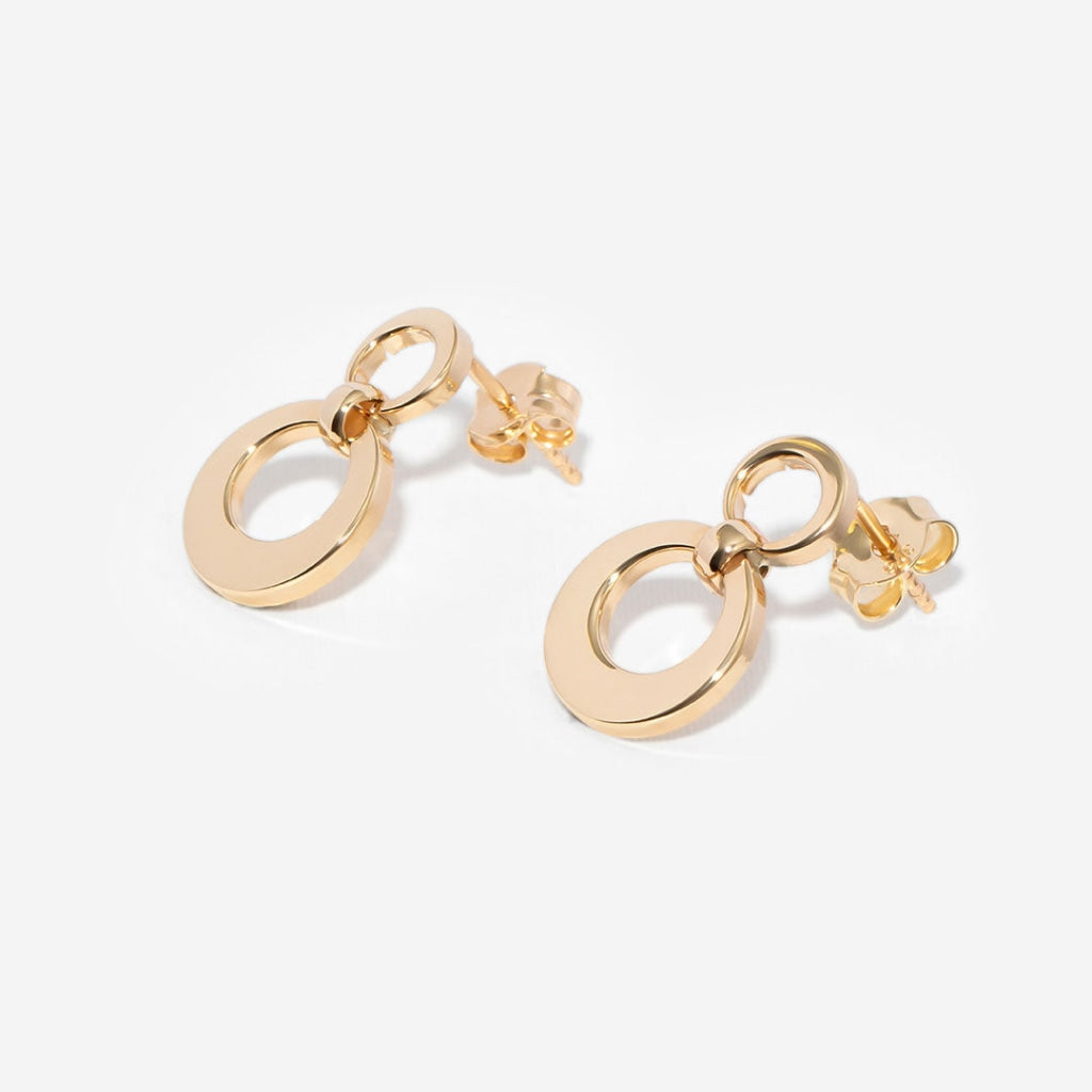 yellow gold drop earrings on white background