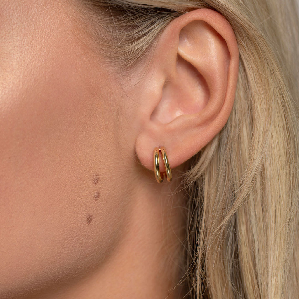 gold hoops in models ear