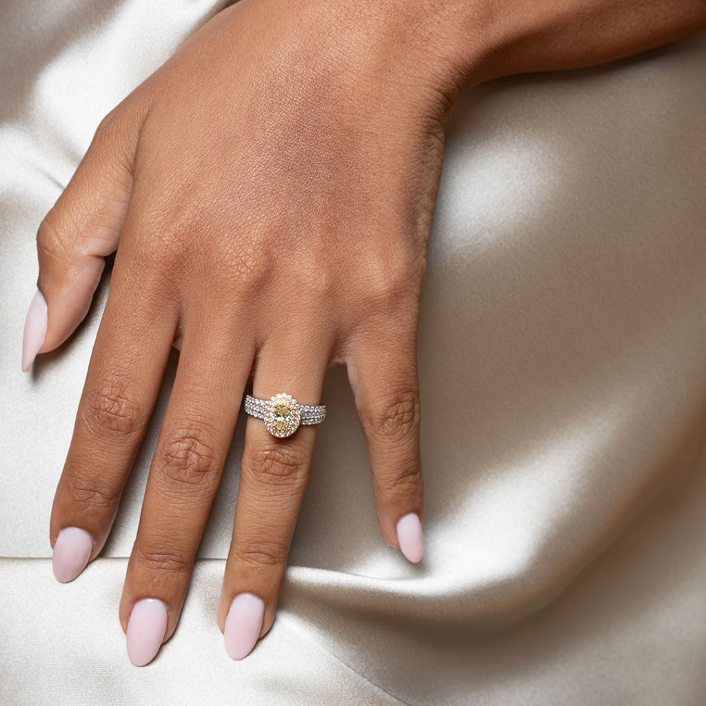 Yellow diamond engagement ring on women's hand