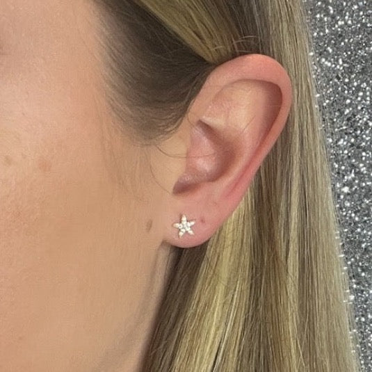 Woman wearing starfish cz earrings
