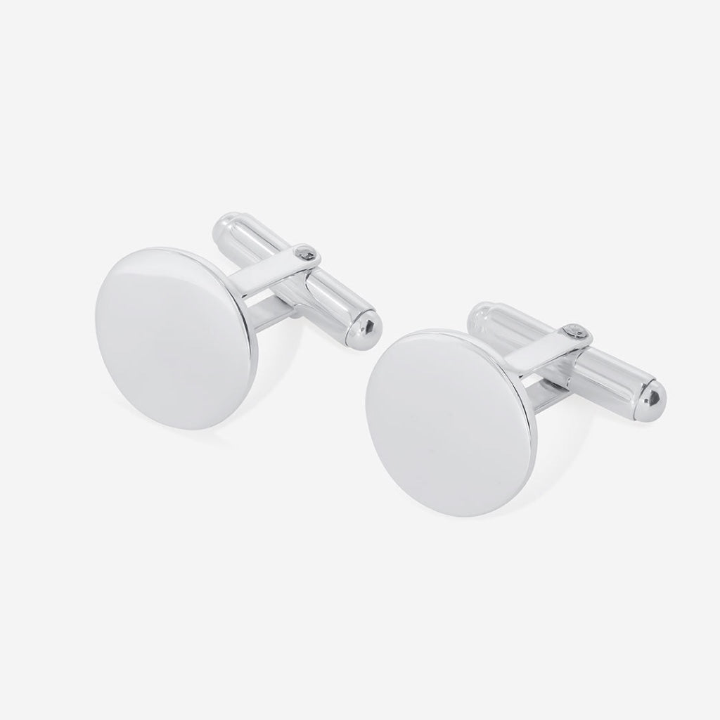 Silver cuff links on grey background