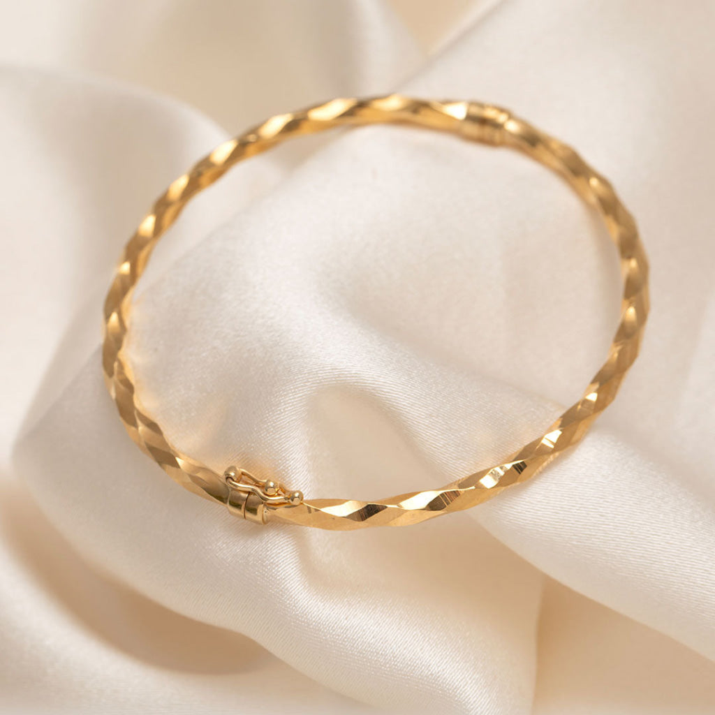 yellow gold diamond cut bangle with clasp