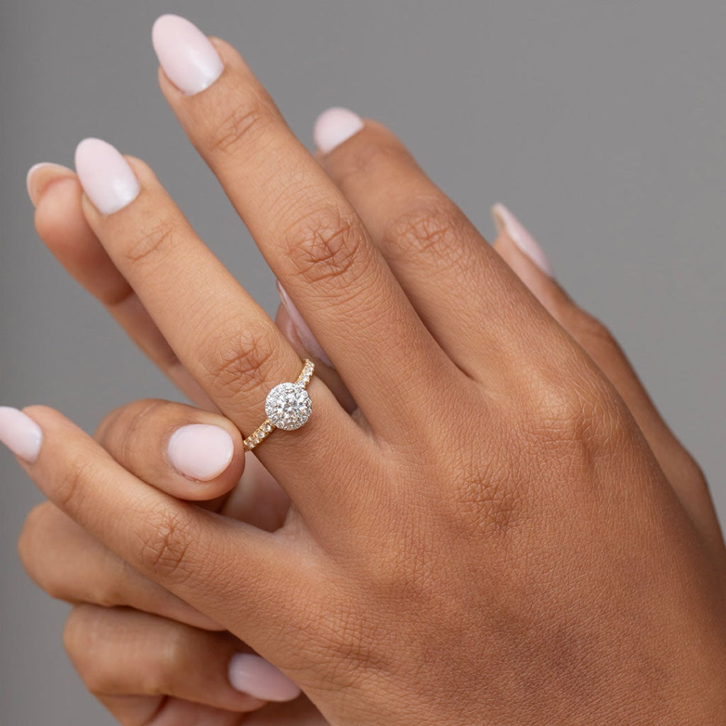 Round diamond engagement ring on ladies hand