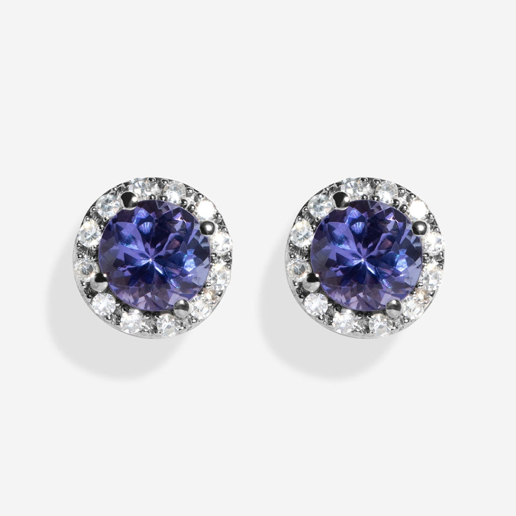 Tanzanite and diamond earrings on white background