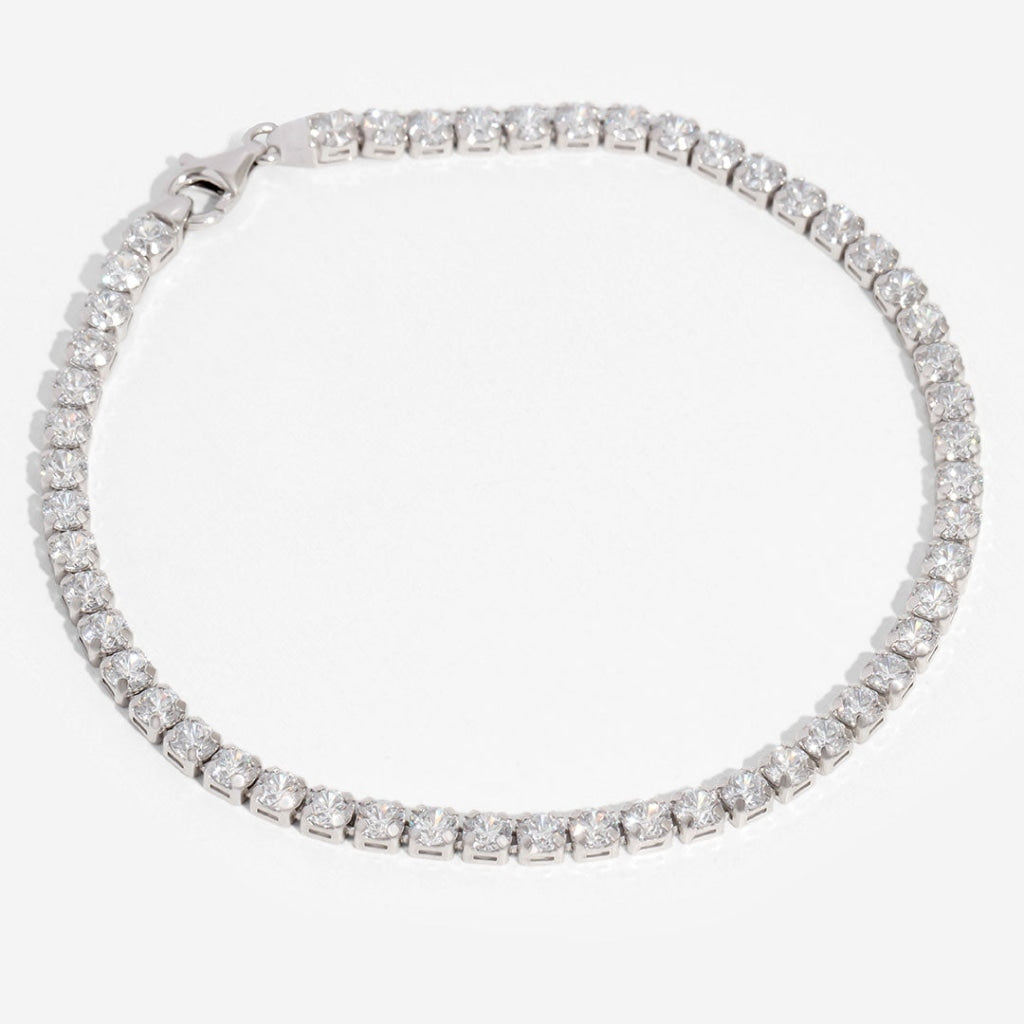 silver tennis bracelet on white background
