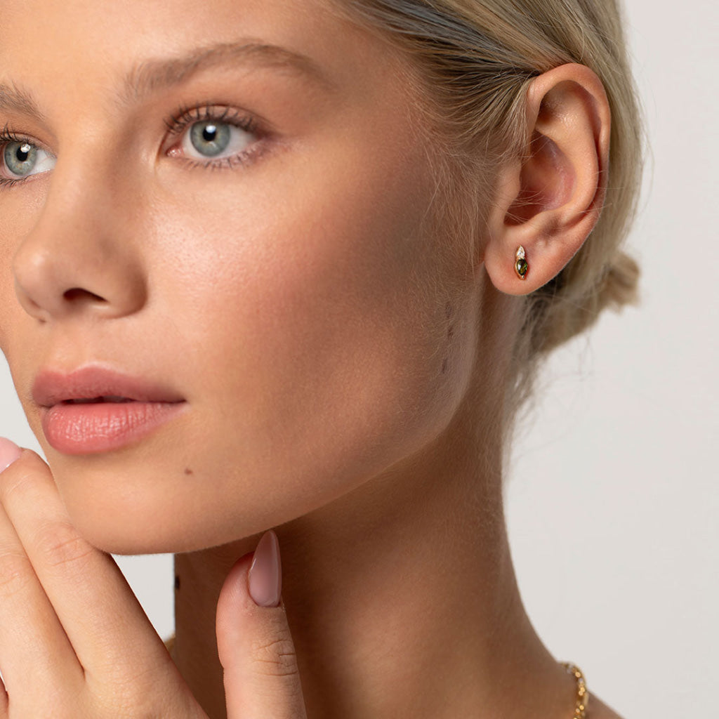 model wearing gemstone earrings