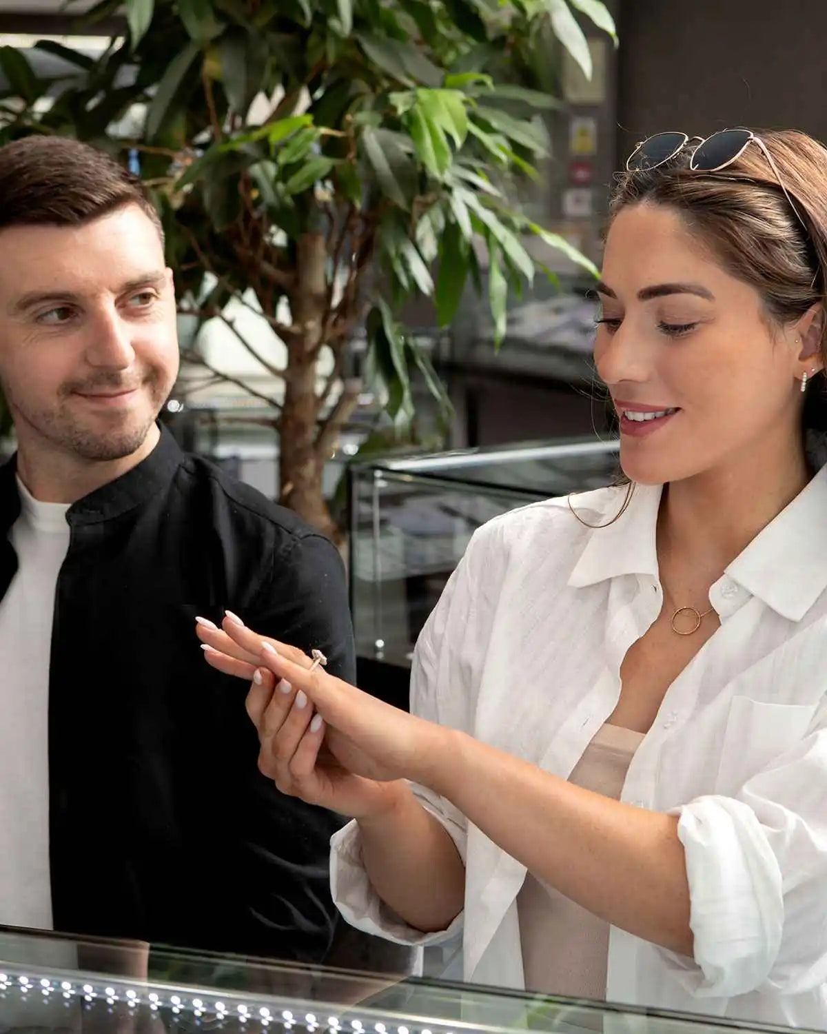 Two people having a conversation at what appears to be a counter or desk.