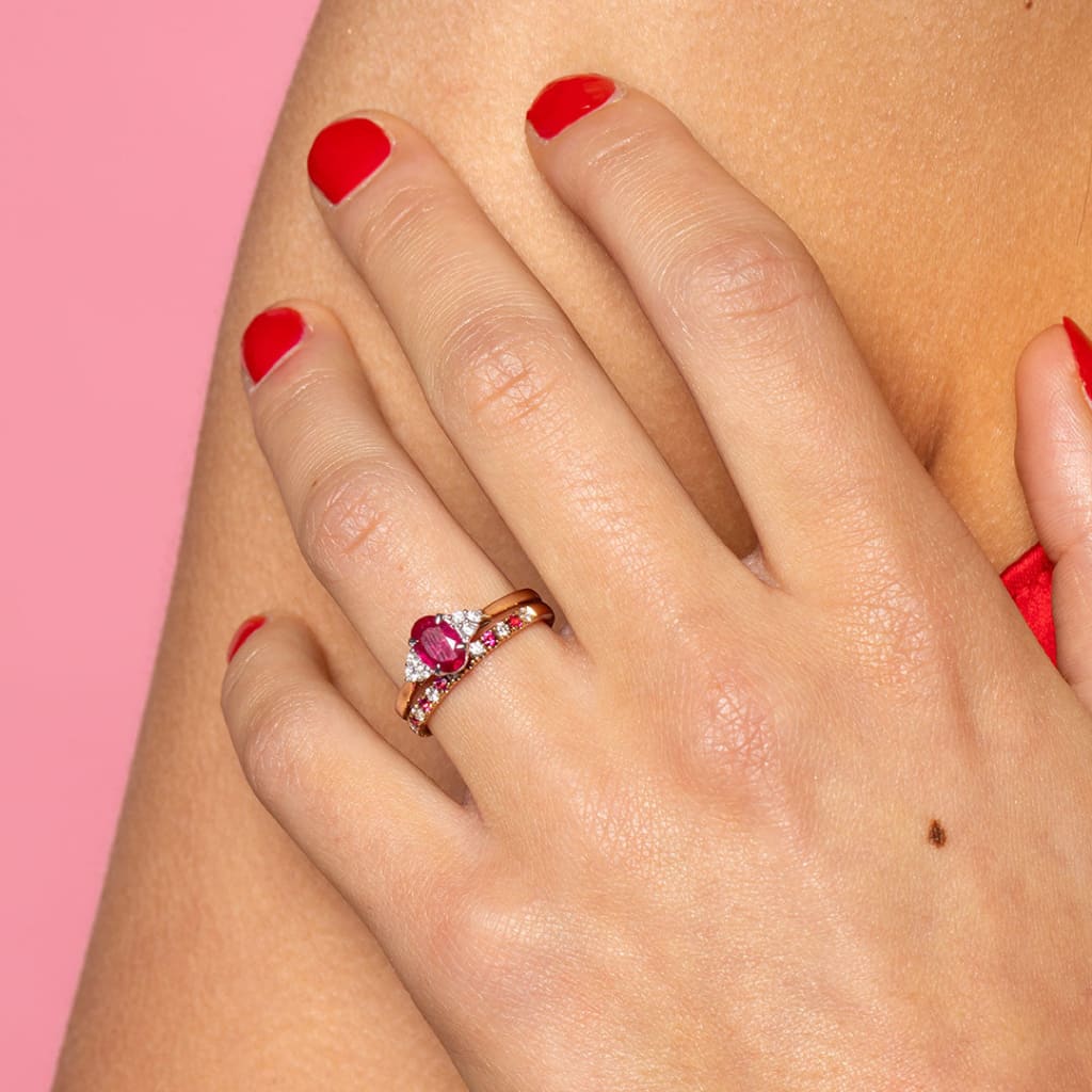 Model wearing 2 rings ruby and diamond side by side.