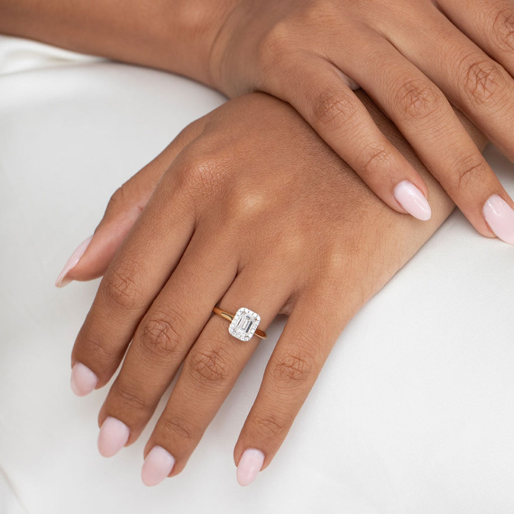 Emerald cut diamond ring on ladies hand - close up