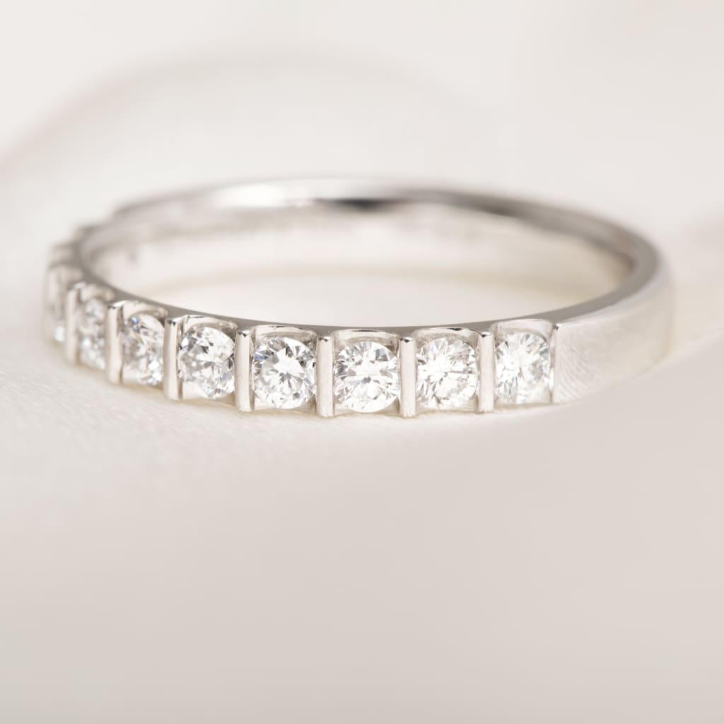 close up of round brilliant cut diamonds set in platinum band