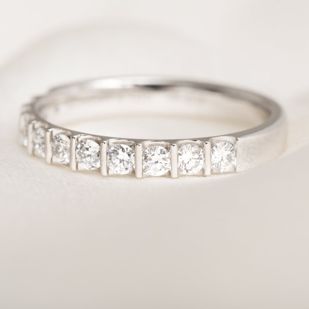 close up of round brilliant cut diamonds set in platinum band