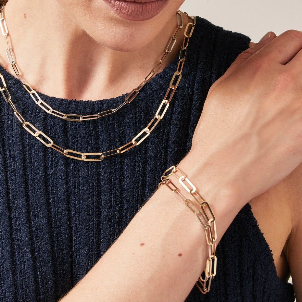 Woman wearing multiple Flat Paper Link Chains - 9ct Gold