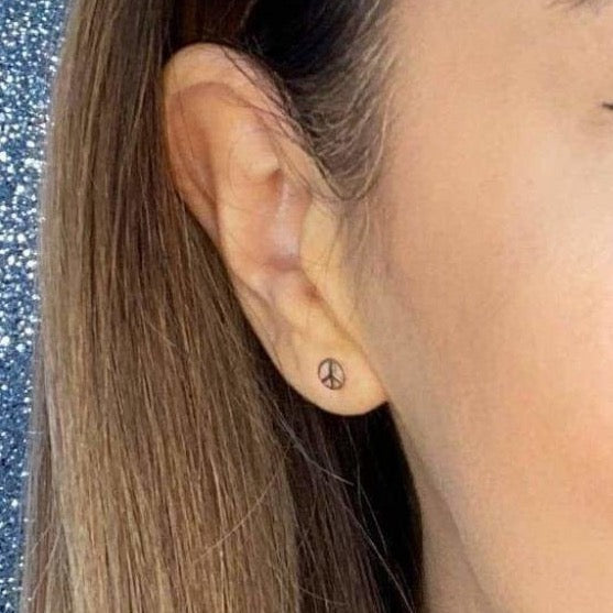 Woman wearing 9ct gold Peace Earrings | Gear Jewellers Dublin