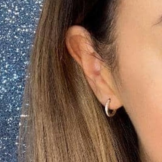 Woman wearing 9ct gold hoop earring